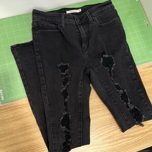 Levi’s 711 skinny black ripped jeans
